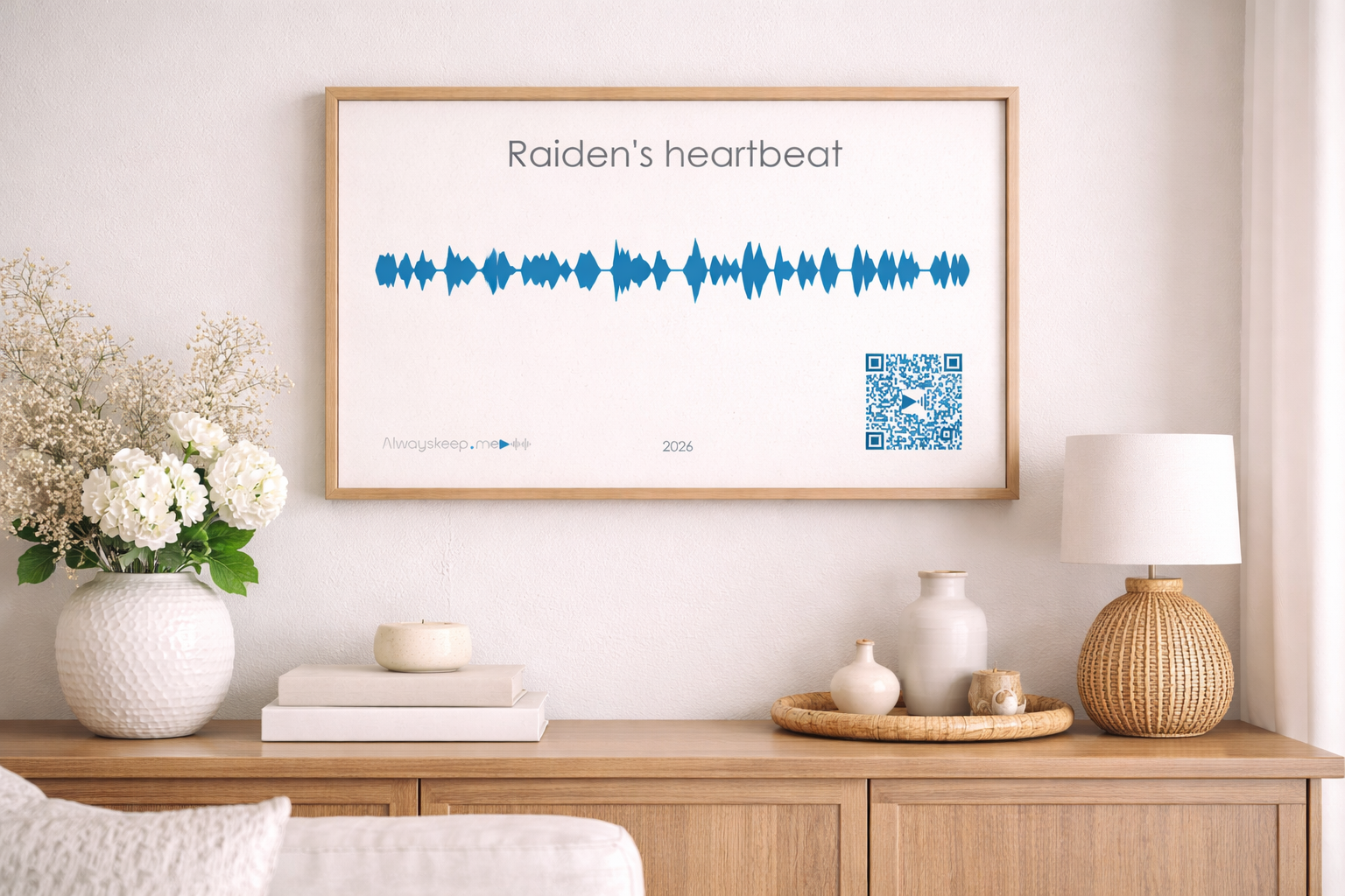 Raiden's heartbeat voice keepsake in a wooden frame displayed on a sideboard with white flowers and a lamp